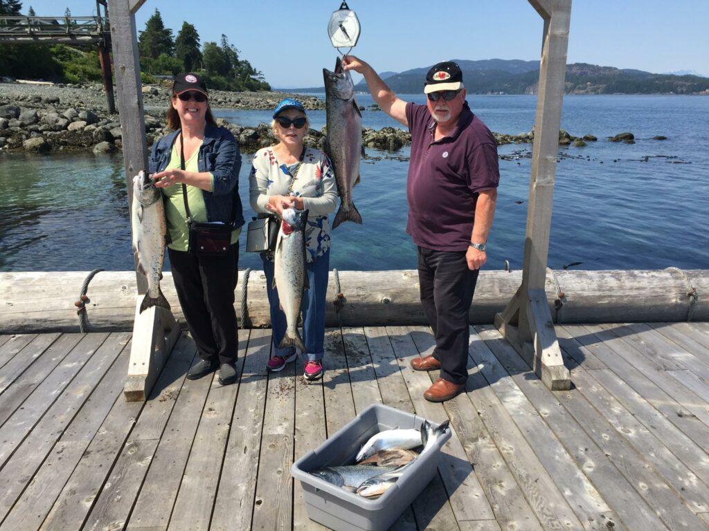 Sylvia Layton from Calgary along with Mr. P, Pete and Marianne choosing Absolute Salmon Fishing Charters image